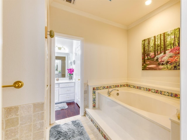 bathroom with crown molding, tile patterned floors, a washtub, and vanity