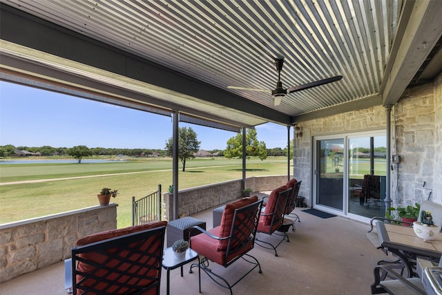 sunroom featuring ceiling fan