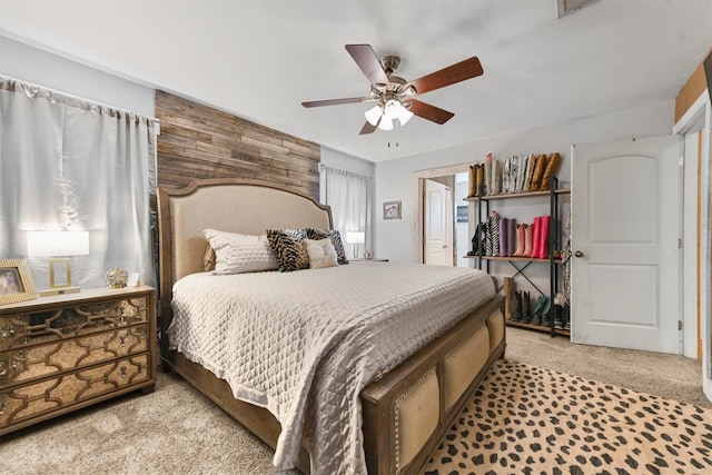 bedroom with ceiling fan and light carpet