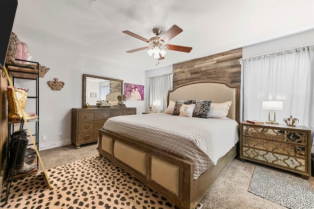 bedroom with ceiling fan and light carpet