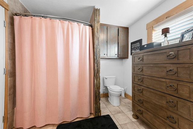 bathroom with tile patterned floors and toilet