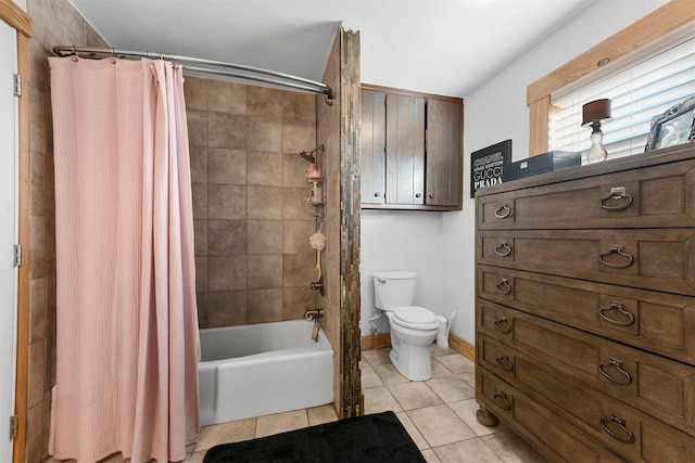 bathroom featuring toilet, tile patterned floors, and shower / tub combo with curtain