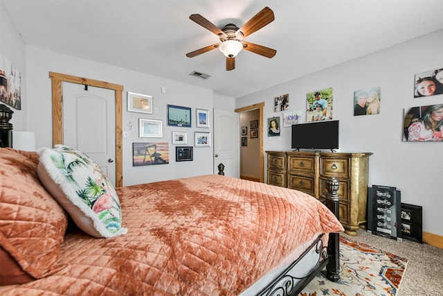 bedroom with ceiling fan, light colored carpet, and a closet