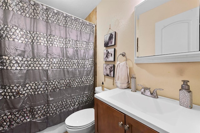 bathroom featuring toilet, vanity, and a shower with shower curtain