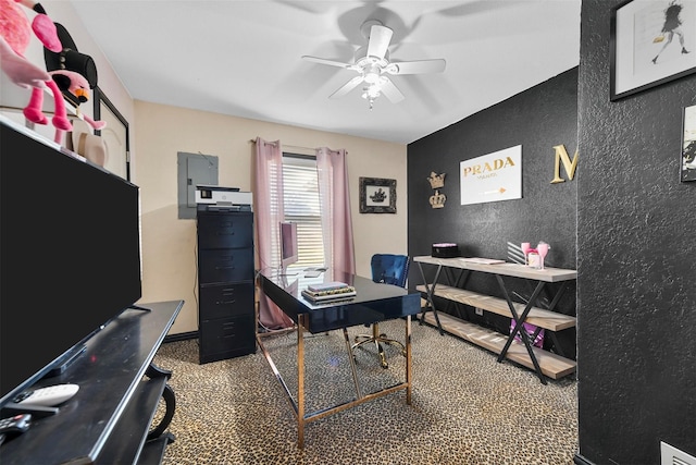 carpeted office with ceiling fan and electric panel