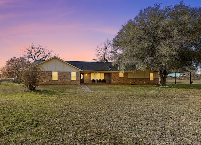 single story home with a lawn