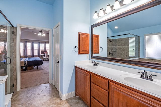 bathroom featuring ceiling fan, vanity, tile patterned floors, and a shower with door