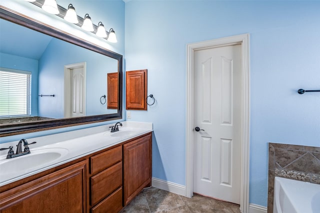 bathroom with vanity, vaulted ceiling, and a washtub