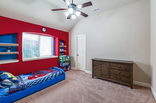 carpeted bedroom with ceiling fan and vaulted ceiling