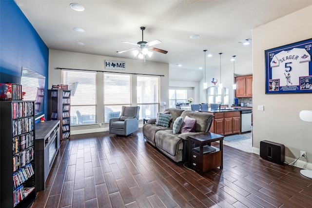 living room featuring ceiling fan and sink