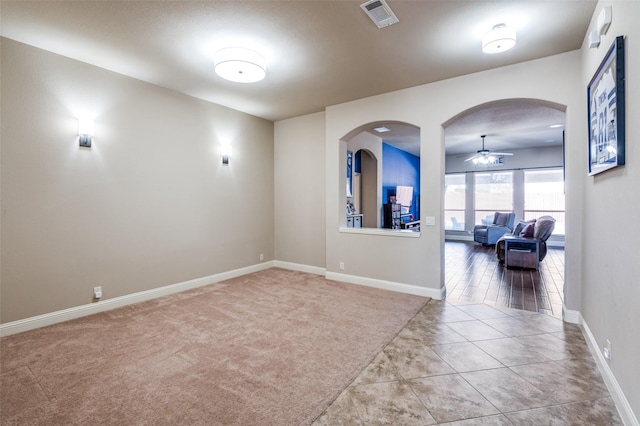 tiled empty room with ceiling fan