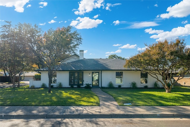 ranch-style home with a front lawn