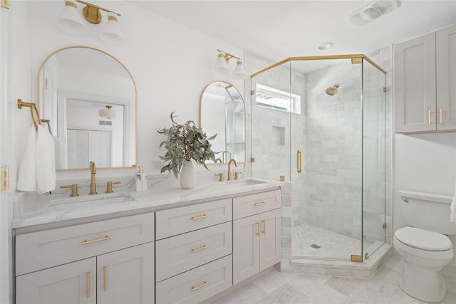 bathroom with a shower with shower door, toilet, and vanity