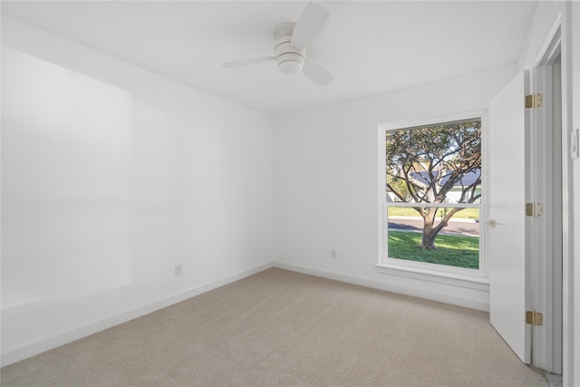 unfurnished room with ceiling fan and light colored carpet