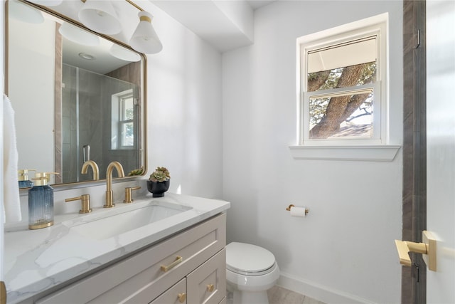 bathroom with toilet, vanity, and an enclosed shower