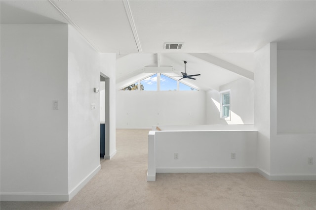 interior space with ceiling fan and vaulted ceiling with beams