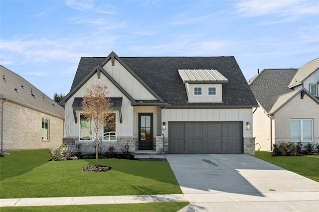 view of front of home with a front yard and a garage