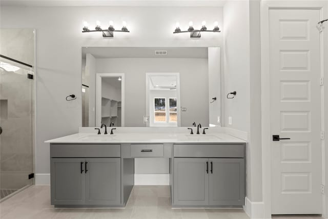 bathroom featuring vanity, an enclosed shower, and tile patterned flooring