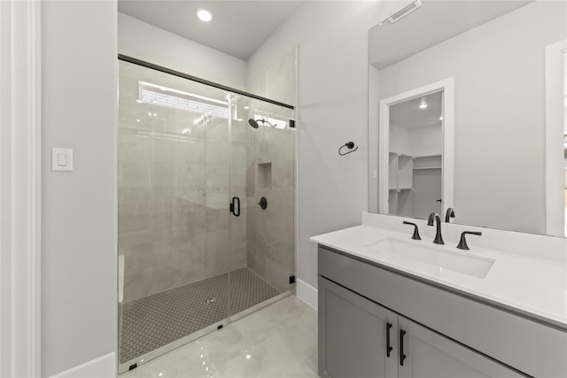 bathroom with vanity and a shower with shower door