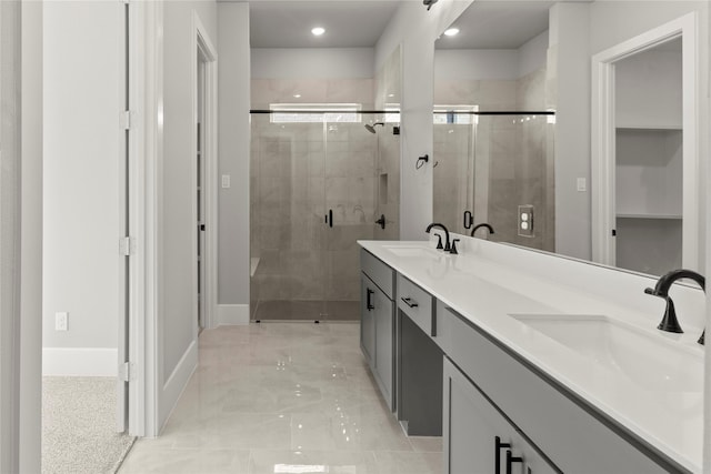 bathroom featuring vanity and a shower with door