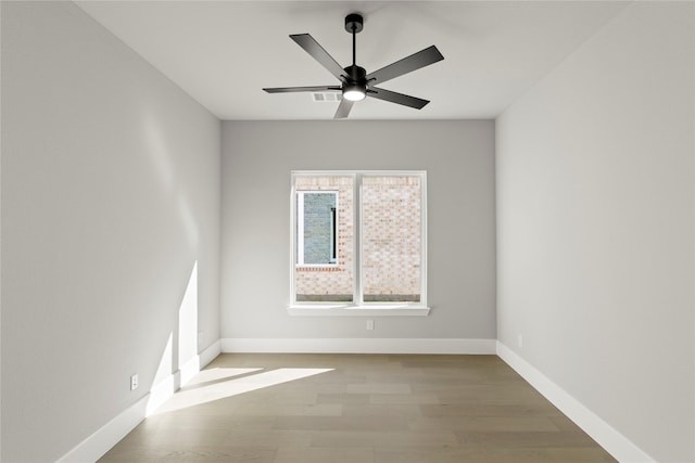 spare room featuring light hardwood / wood-style flooring and ceiling fan