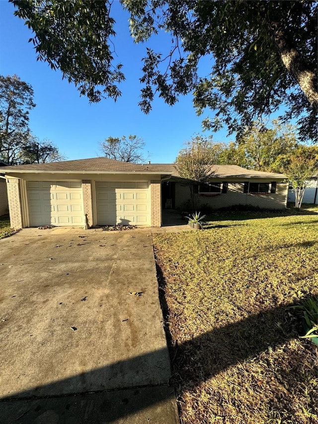 ranch-style home featuring a front yard and a garage