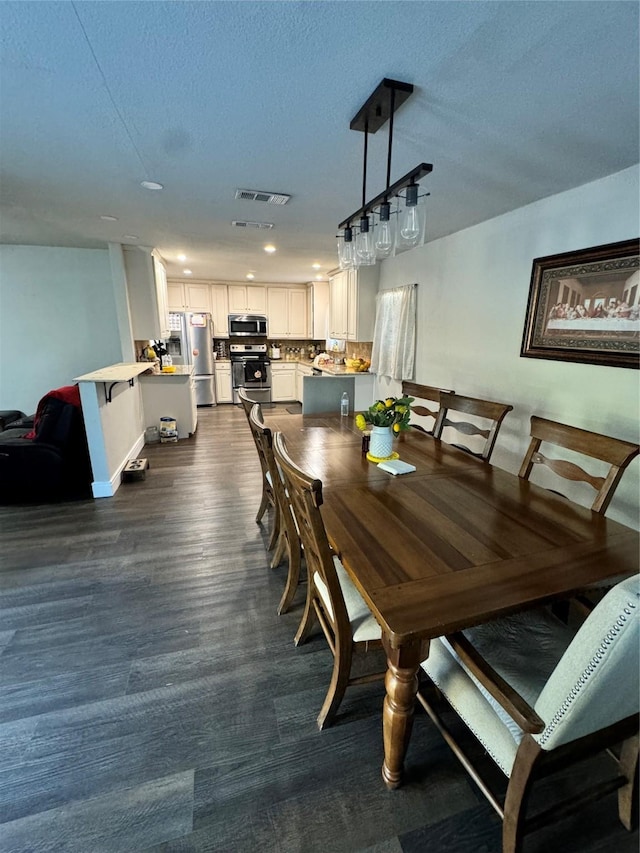 dining space featuring a textured ceiling