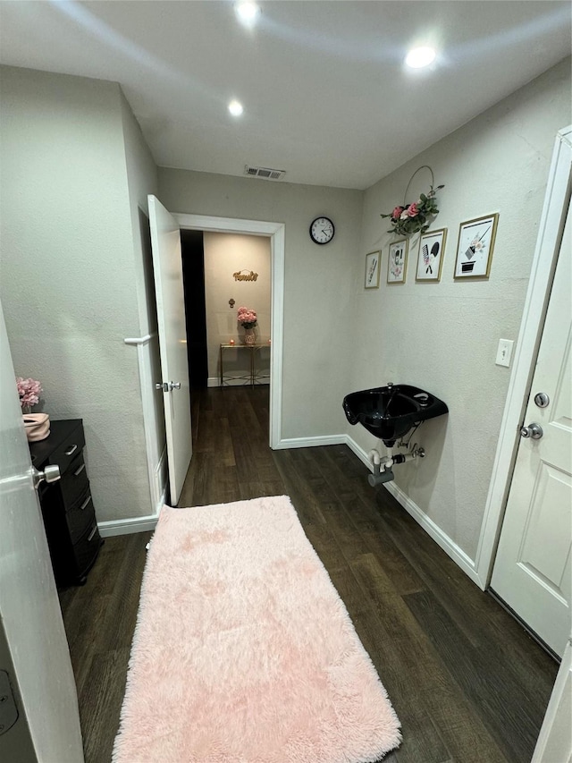 hall with dark wood-type flooring