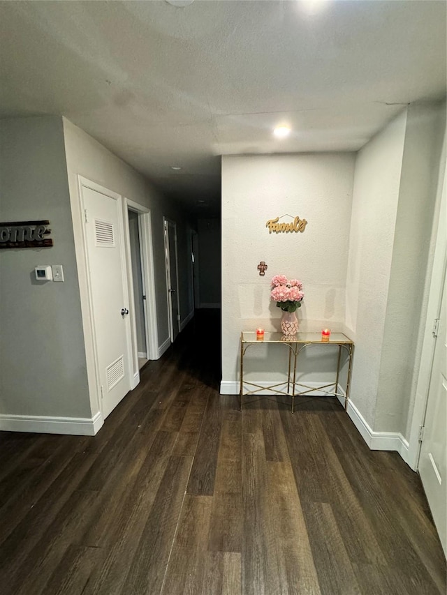 hallway featuring dark hardwood / wood-style flooring