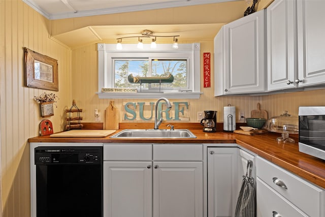 kitchen with wood counters, black dishwasher, sink, white cabinets, and ornamental molding