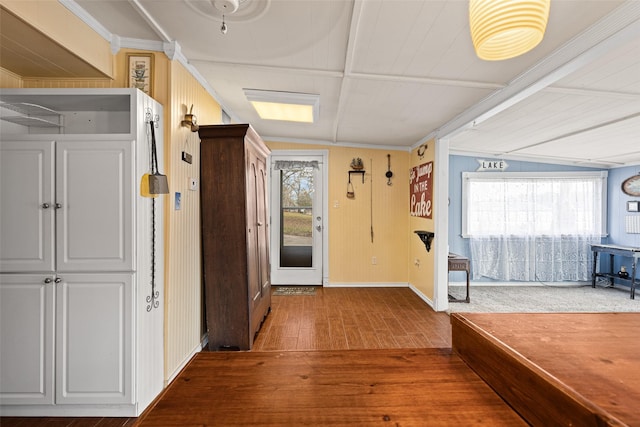 hall with ornamental molding and hardwood / wood-style floors