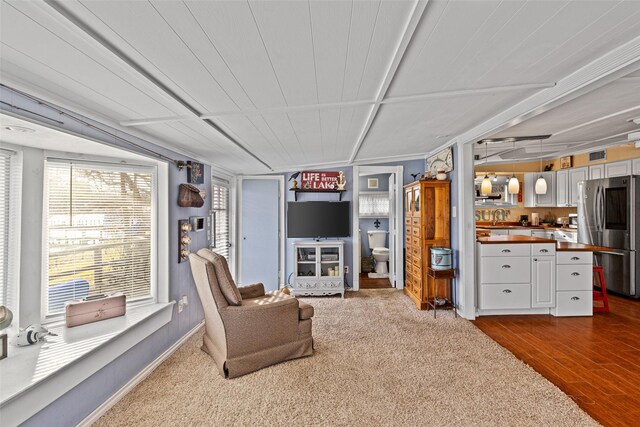 living room with dark colored carpet