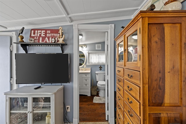 interior space with vanity, wood-type flooring, ornamental molding, and toilet