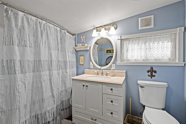 bathroom featuring a shower with curtain, vanity, and toilet