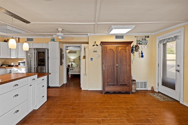 kitchen featuring stainless steel appliances, dark hardwood / wood-style floors, white cabinets, wood counters, and decorative light fixtures