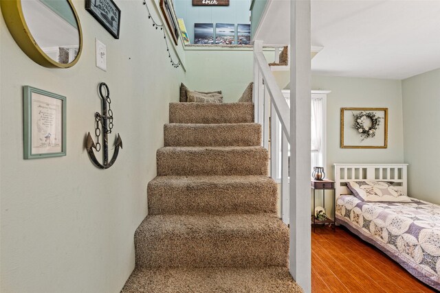 bedroom featuring light carpet, ceiling fan, crown molding, and multiple windows