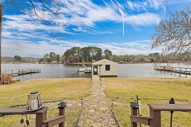 view of dock with a yard and a water view