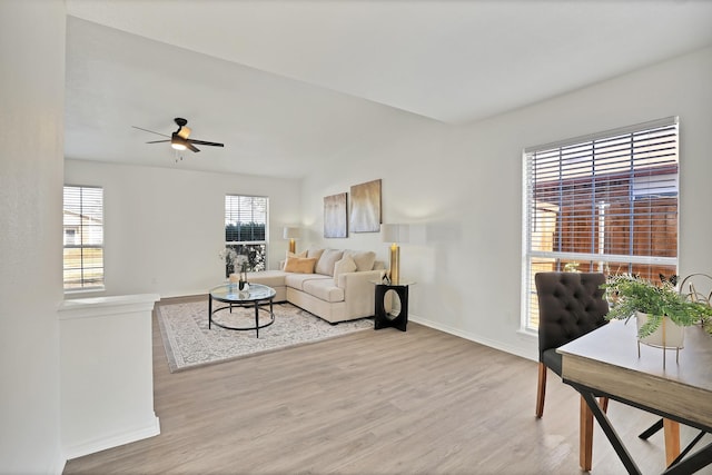 living room featuring light wood-type flooring and ceiling fan