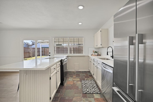 kitchen with a breakfast bar area, sink, and stainless steel appliances