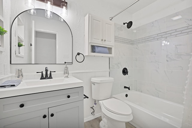 full bathroom featuring toilet, tiled shower / bath, wood-type flooring, and vanity