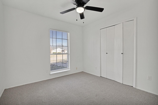 unfurnished bedroom featuring ceiling fan, carpet, and a closet