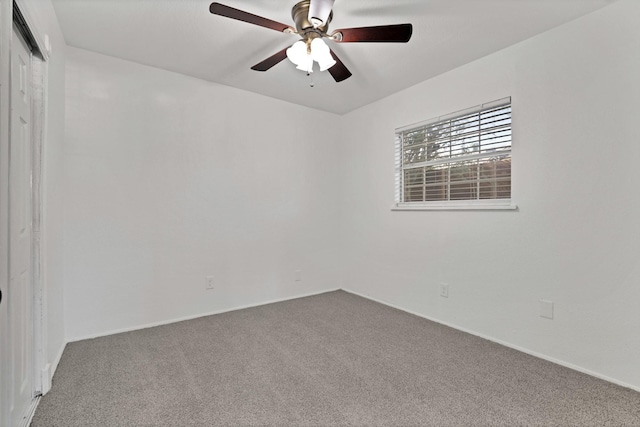 spare room featuring ceiling fan and carpet