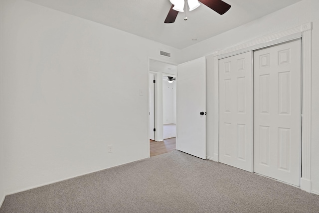 unfurnished bedroom with ceiling fan, a closet, and carpet flooring