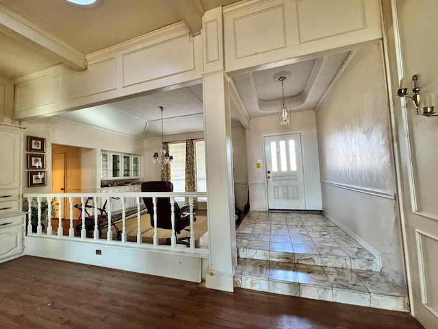 foyer featuring beam ceiling and hardwood / wood-style flooring