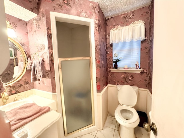 bathroom featuring a textured ceiling, tile patterned flooring, and a shower with door