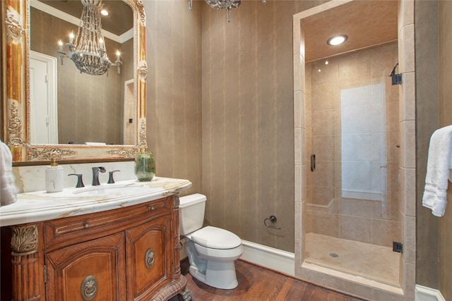 full bath with vanity, wood finished floors, tiled shower, toilet, and a notable chandelier