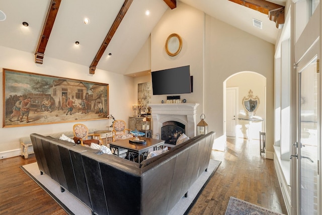 living room with high vaulted ceiling, hardwood / wood-style flooring, and beamed ceiling