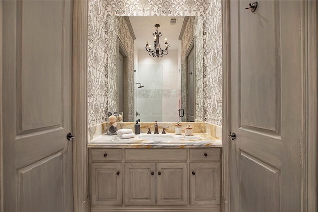 bathroom featuring a chandelier, visible vents, a shower stall, and vanity