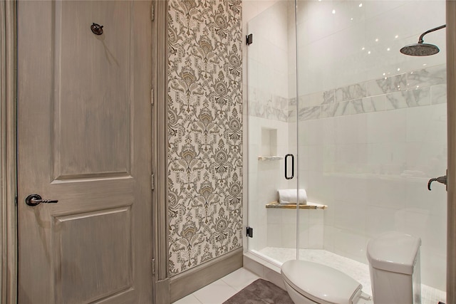 full bath featuring tile patterned floors, a shower stall, and toilet