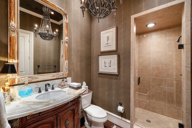 bathroom featuring an enclosed shower, ornamental molding, toilet, vanity, and a chandelier